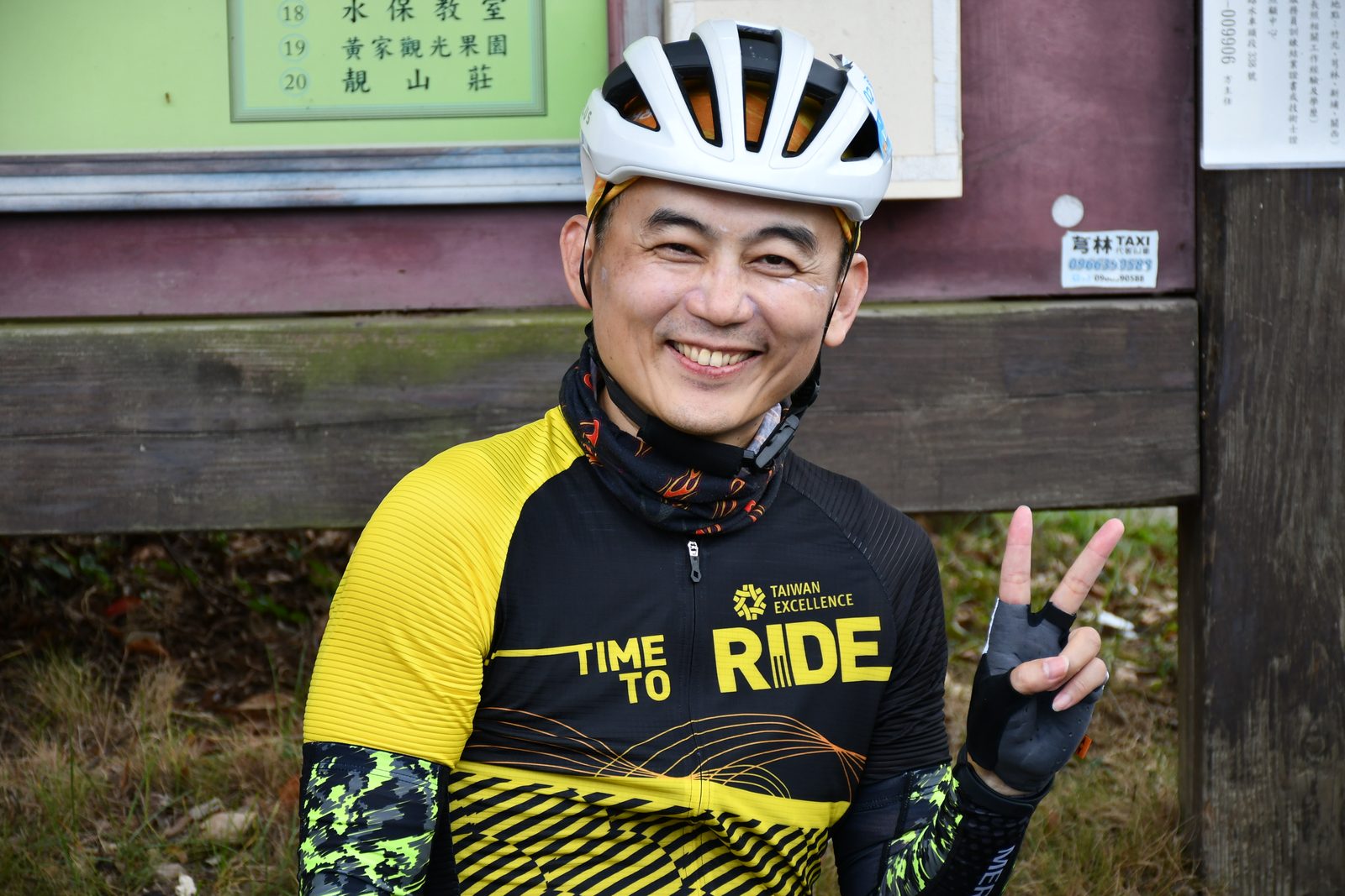 A rider giving a peace sign in a 'Time to Ride' jersey