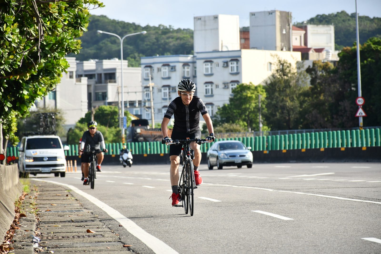 Two riders leading the pack down a city street