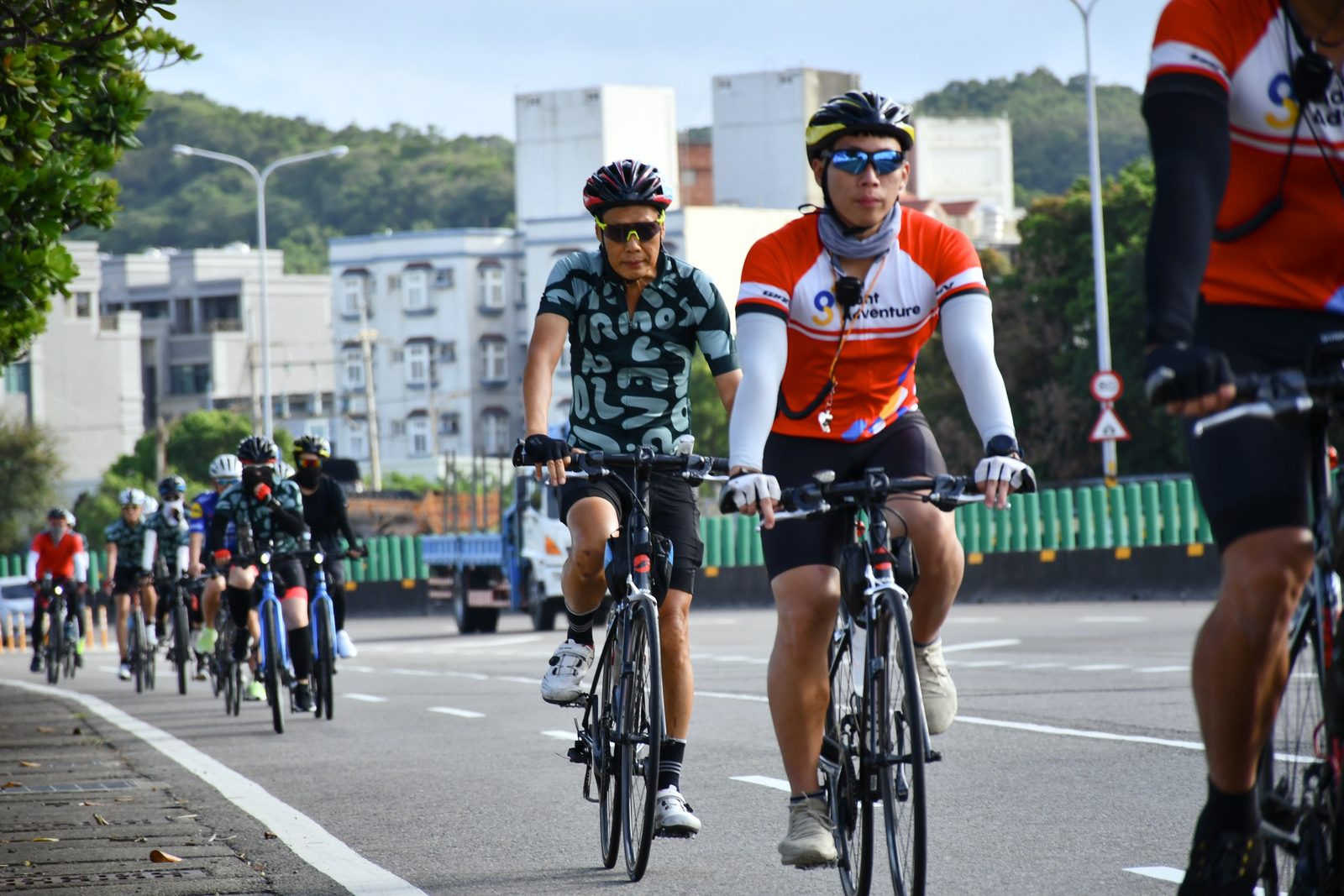 Lead riders pulling the pack along an open road