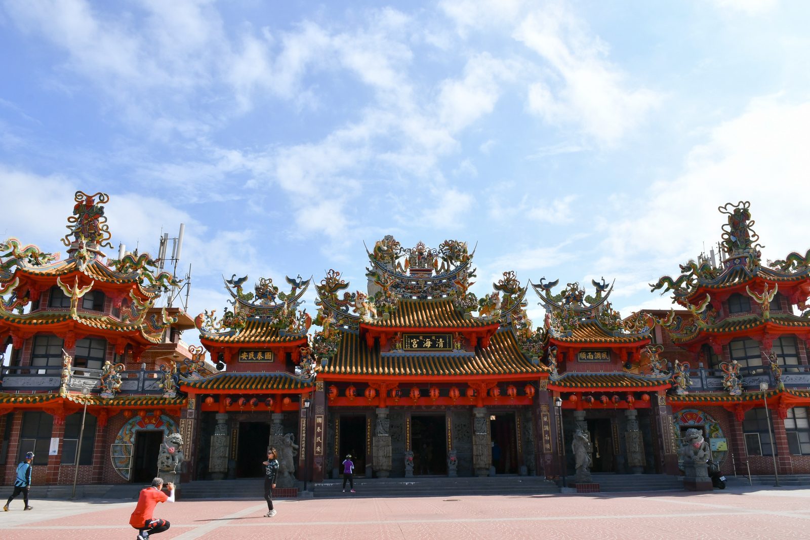 The grand facade of Qinghai Temple, riders pausing for photos