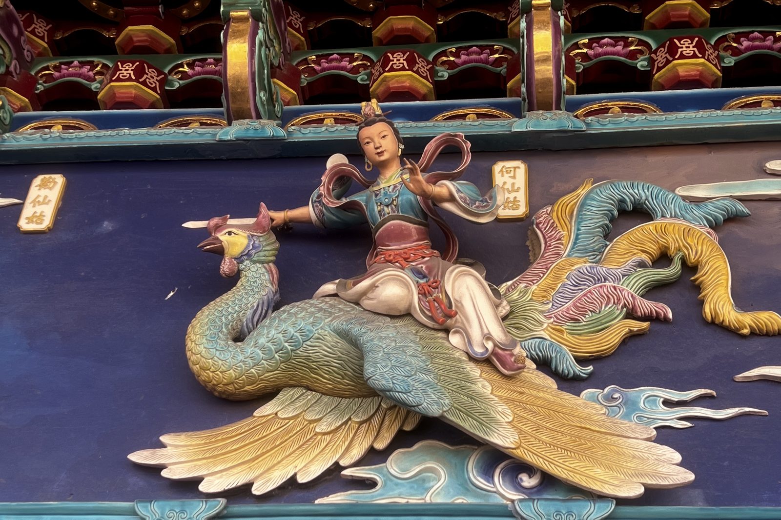 A carved temple relief of an immortal riding a phoenix