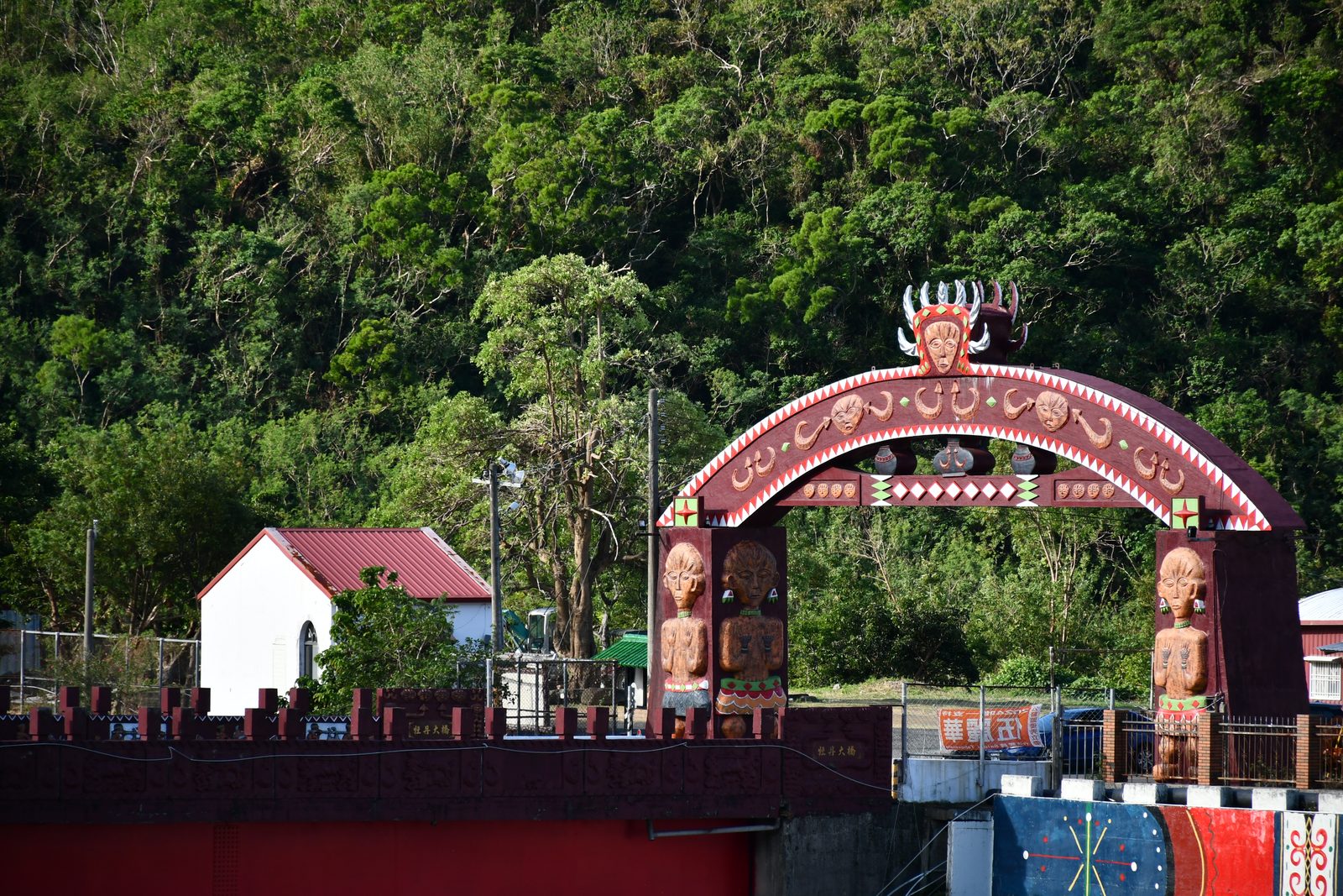 An ornately carved indigenous gateway bridge