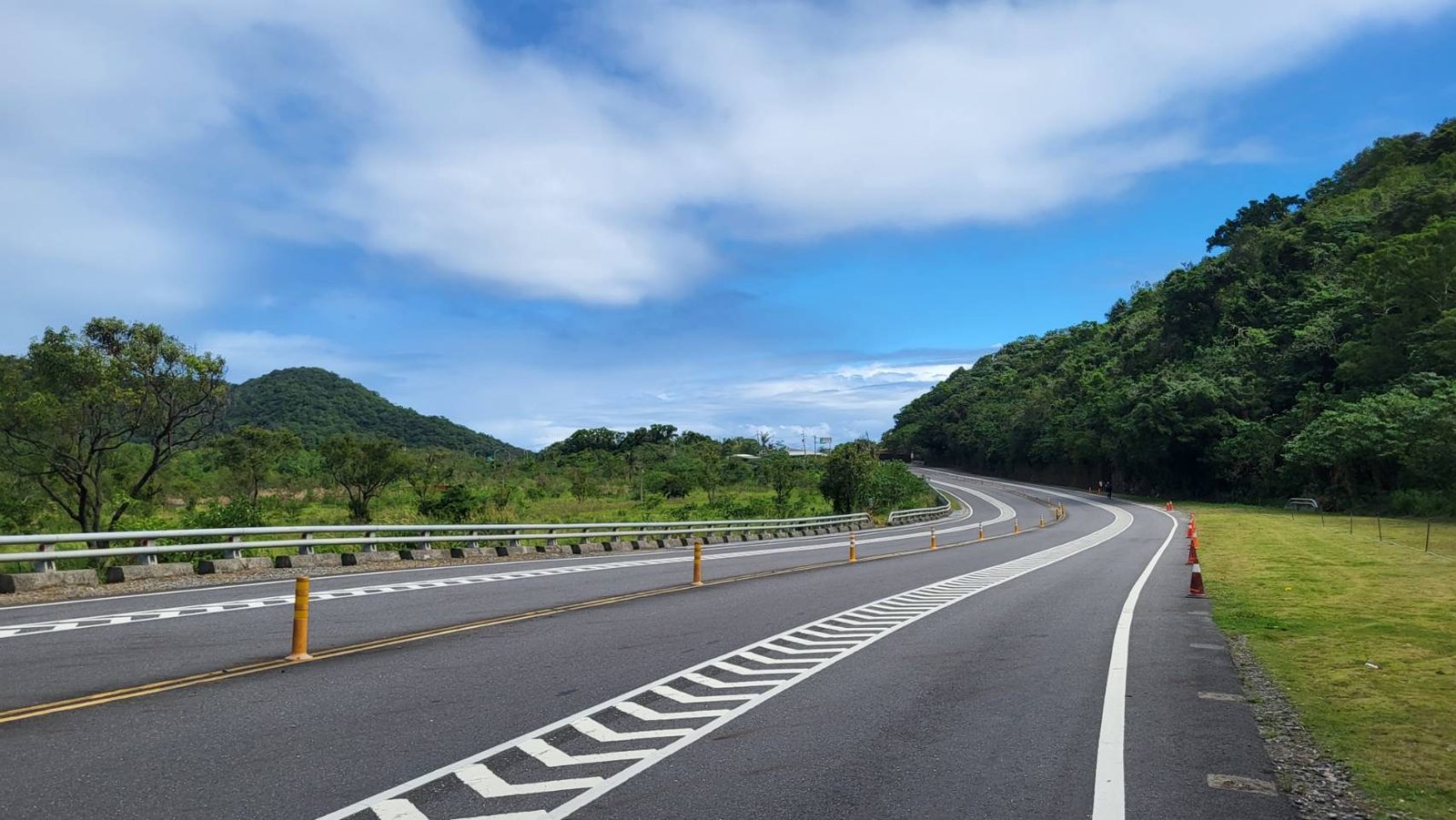 An empty winding road through the hills