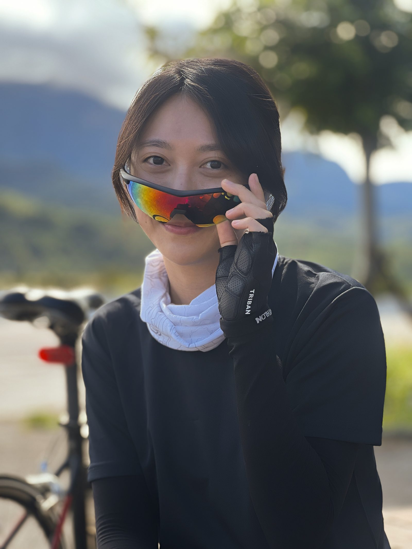 Peeking over a pair of rainbow-lensed shades