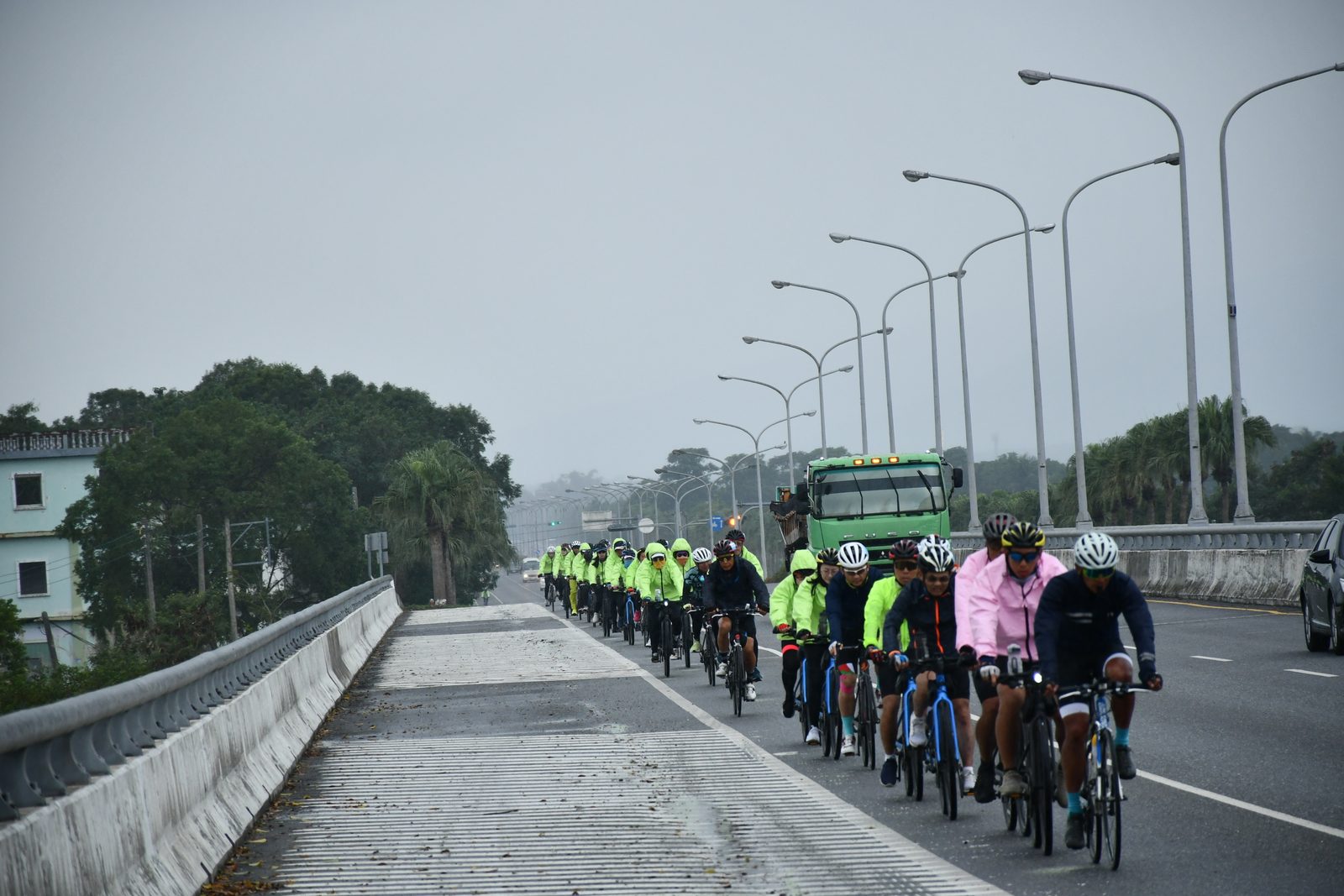 The full pack crossing a long bridge in the rain