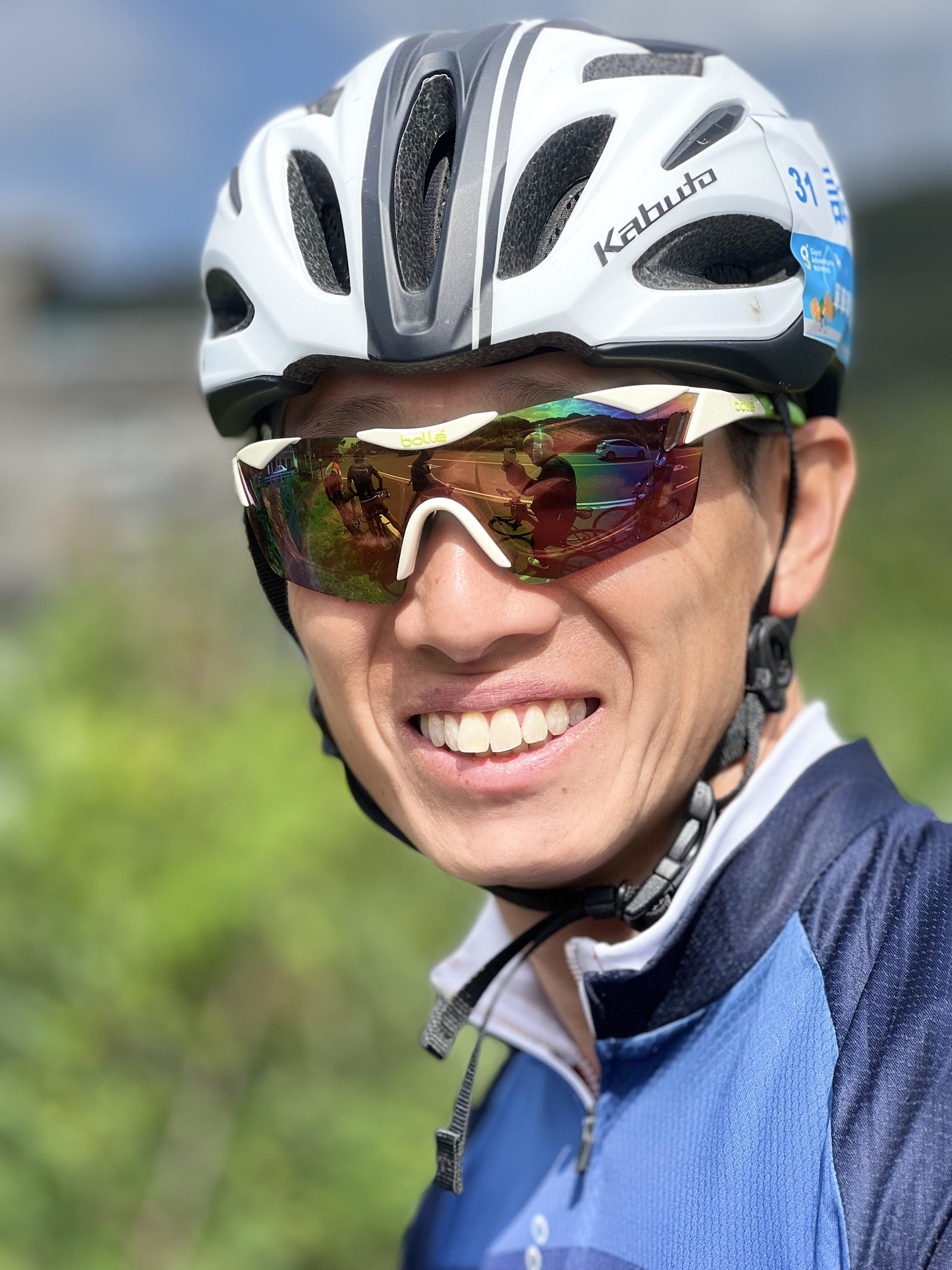 A close-up portrait, sunglasses reflecting the ride